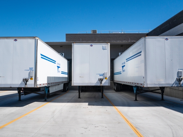 Three white commercial vehicle trailers