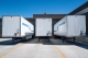 Three white commercial vehicle trailers